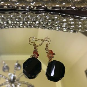 Black earrings with small stone detail.